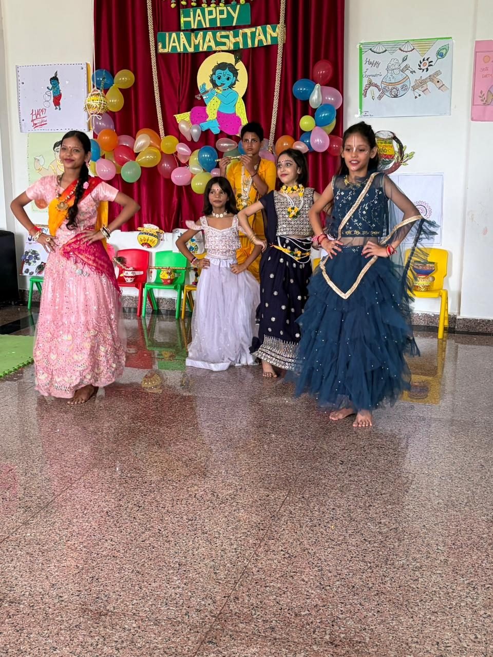 Group presentation before the Janmashtami backdrop
